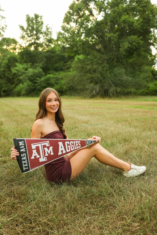 Senior holding a Texas A&M Aggies pennant