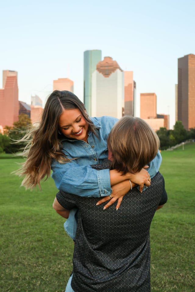 Couple embracing with the Houston skyline behind