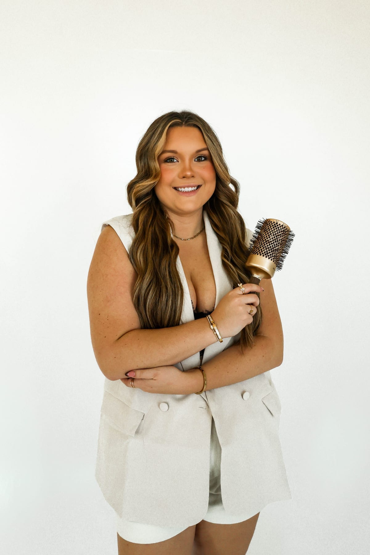 Madi Atkisson holding a round hair brush