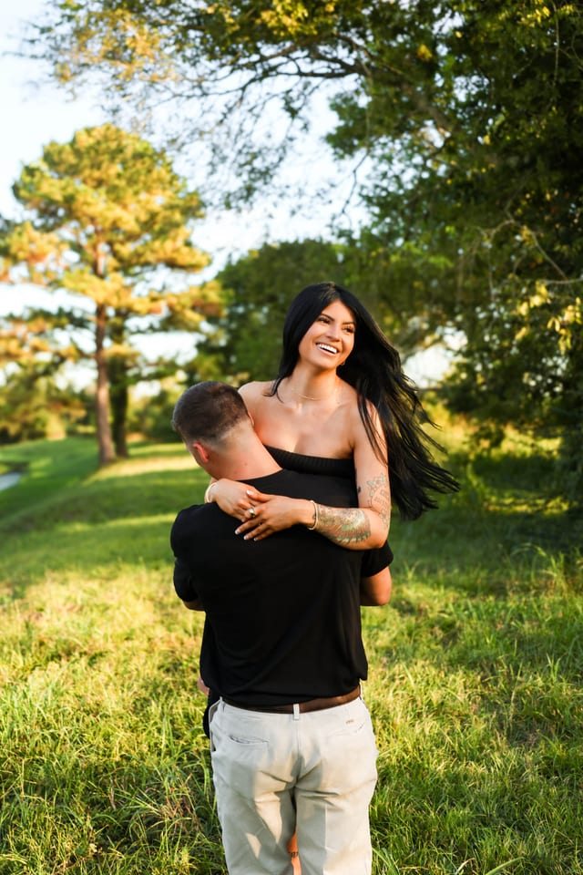 Couple embracing in a sunlit green field