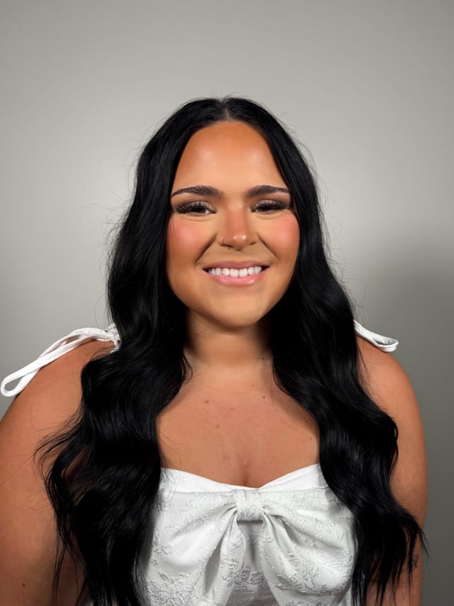 Soft glam makeup with long glossy black waves