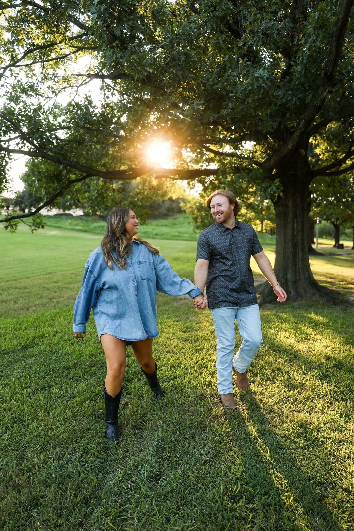 Couple walking through a sunlit field