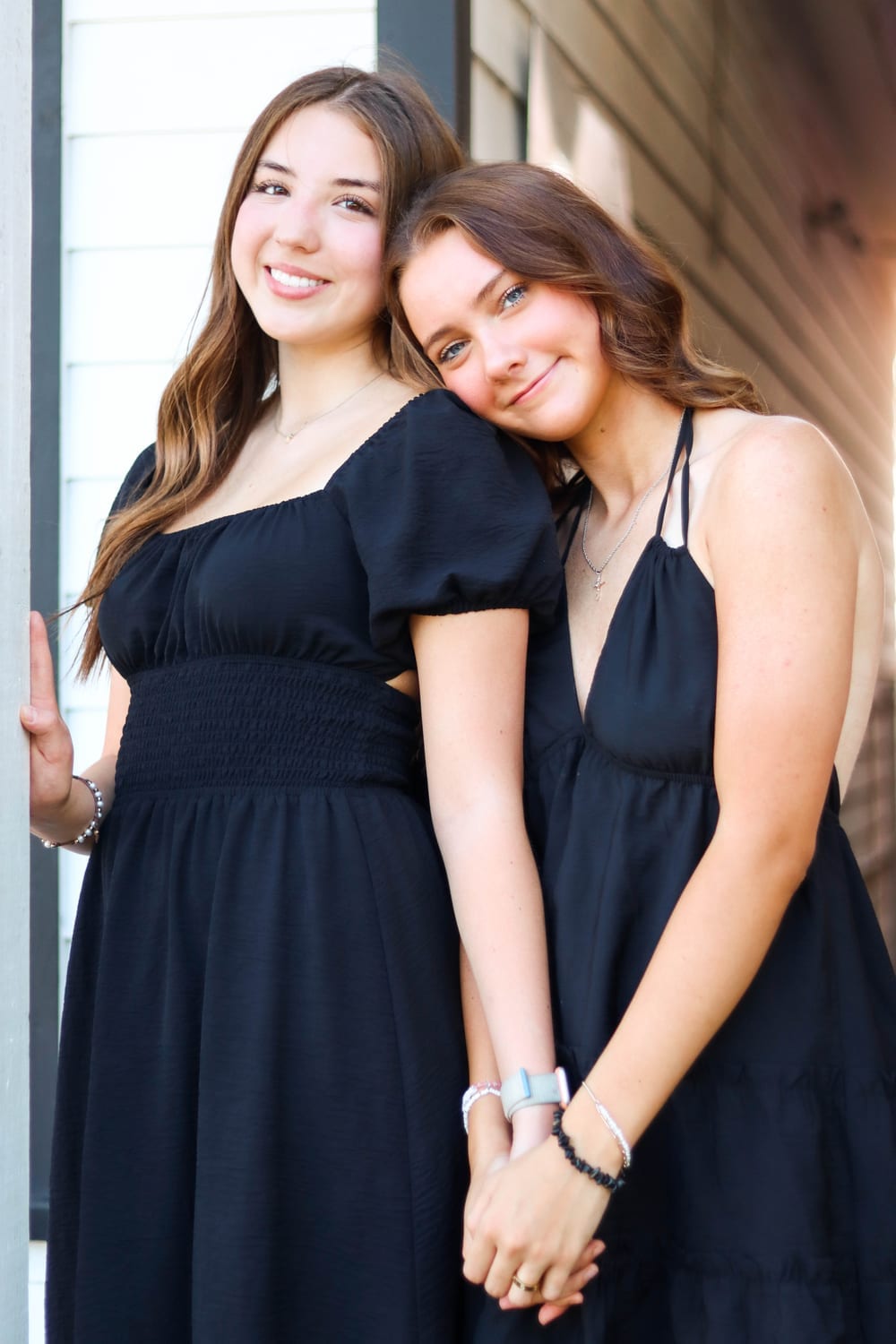 Two sisters in matching black dresses